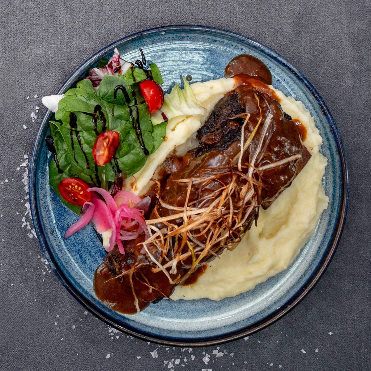 Coastă de vită gătită lent în vin, servită cu piure cremos de cartofi